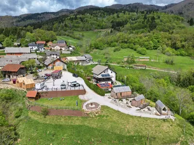 an aerial view of a small village in the mountains at GoLife Center Glamping in Laze v Tuhinju