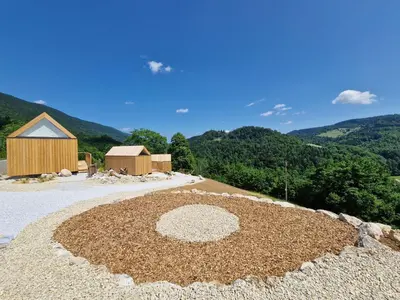 a large pile of dirt in front of a building at GoLife Center Glamping in Laze v Tuhinju