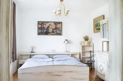 a bedroom with a bed and a painting on the wall at Grajska kmetija in Kočevje