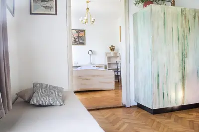 a bedroom with a bed and a room with a wooden floor at Grajska kmetija in Kočevje
