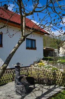 a house with a fence and a bench in front of it at Grajska kmetija in Kočevje