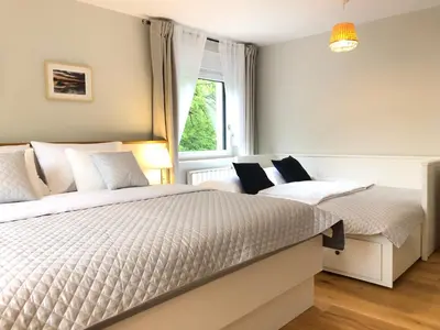two beds in a bedroom with a window at Angel Boutique Home - Entire premium house in Laško