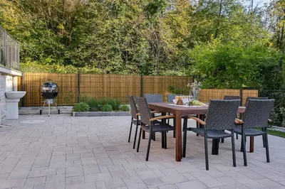 a wooden table and chairs on a patio at Angel Boutique Home - Entire premium house in Laško