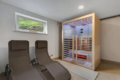 a room with two chairs and a wine cellar at Angel Boutique Home - Entire premium house in Laško