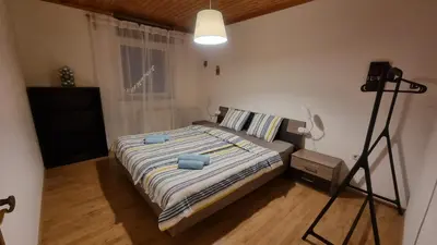 a bedroom with a bed with blue pillows on it at Apartma Uršič in Kranjska Gora