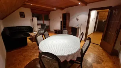 a living room with a table and chairs and a couch at Apartma Uršič in Kranjska Gora