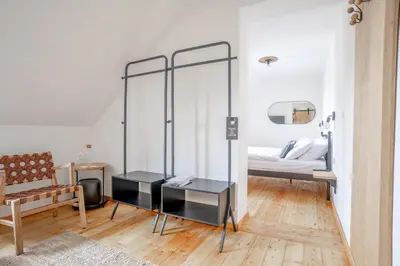 a bedroom with a bed and a mirror at SIBON Wine & Spa Resort Jeruzalem in Ljutomer