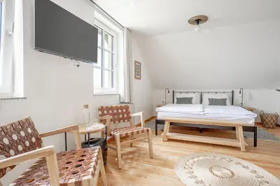 a bedroom with a bed and a flat screen tv at SIBON Wine & Spa Resort Jeruzalem in Ljutomer