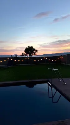 a view of a swimming pool at sunset at VOO residence in Malečnik