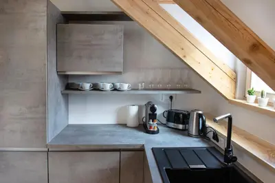 a kitchen with a sink and a counter top at Bright & Spacious Loft In The Heart Of Old Town in Ljubljana