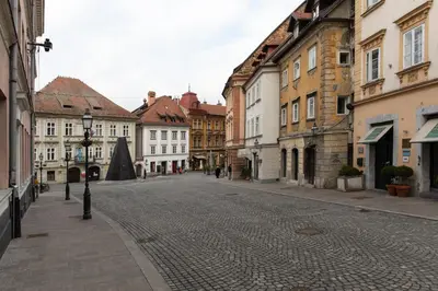 an empty street in an old town with buildings at Bright & Spacious Loft In The Heart Of Old Town in Ljubljana