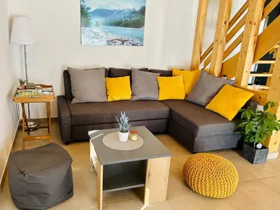 a living room with a couch and a table at HOLIDAY HOUSE - River Bača in Most na Soči