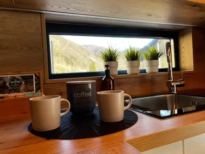 two coffee mugs on a tray on a kitchen counter at HOLIDAY HOUSE - River Bača in Most na Soči