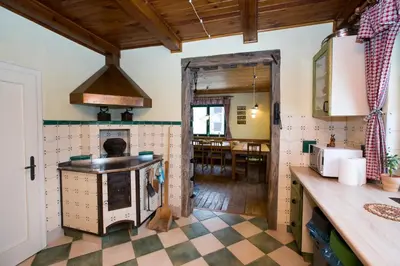 a kitchen with a checkered floor at Cottage Suha in Bohinj