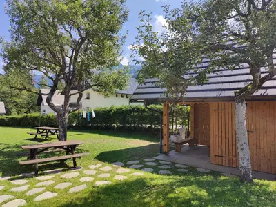 a picnic shelter and a picnic table in a park at Cottage Suha in Bohinj