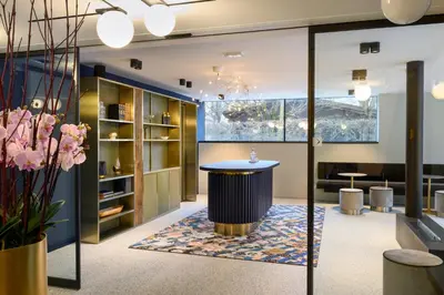 a lobby with a counter and a table in a room at Hotel Čad in Ljubljana