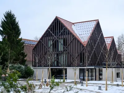 a large building with a gambrel roof at Hotel Čad in Ljubljana