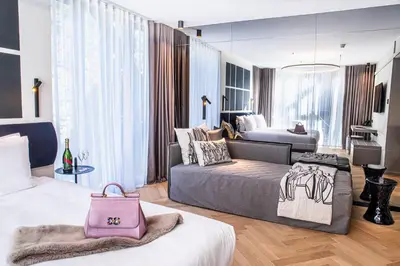 a hotel room with two beds and a pink bag at Hotel Čad in Ljubljana
