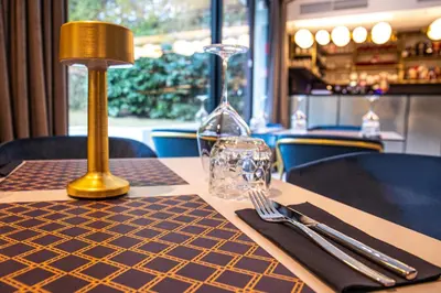 a table with a fork and a napkin on a table at Hotel Čad in Ljubljana
