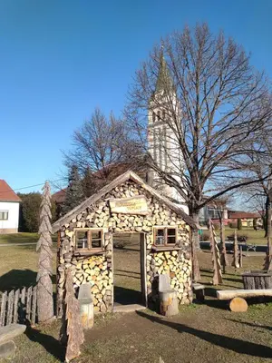 a small log house with a tower in a yard at Apartma MAX in Moravske Toplice
