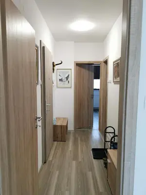 a room with a hallway with wooden floors and a door at Apartma Kuhar in Kranjska Gora