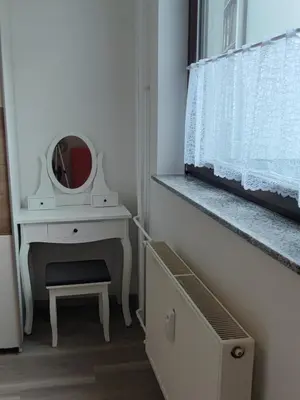 a bedroom with a dressing table and a mirror at Apartma Kuhar in Kranjska Gora
