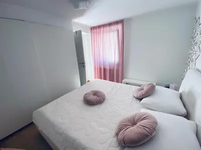 a bedroom with a bed with two pillows on it at Apartma KAMNITNK in Škofja Loka