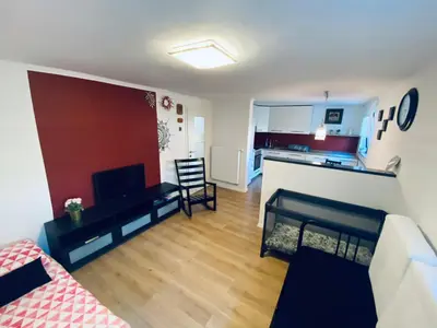a living room with a couch and a kitchen at Apartma KAMNITNK in Škofja Loka