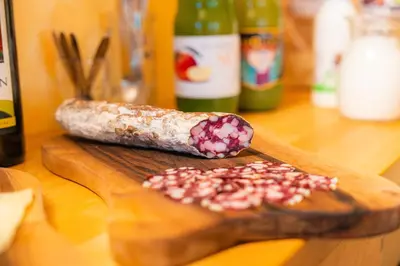 a wooden cutting board with two types of food at Organic Tourist Farm Pri Plajerju in Trenta