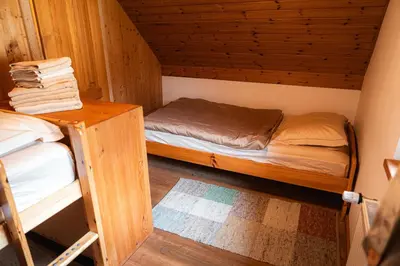 a small room with two bunk beds in a cabin at Organic Tourist Farm Pri Plajerju in Trenta