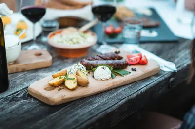 a wooden table with a cutting board with food on it at Organic Tourist Farm Pri Plajerju in Trenta