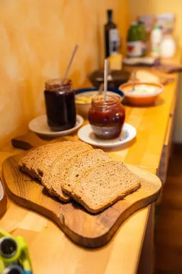 a loaf of bread on a cutting board on a counter at Organic Tourist Farm Pri Plajerju in Trenta