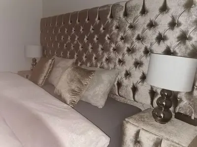 a bedroom with a bed with a headboard and a lamp at Apartman PIKY No.10 in Moravske Toplice