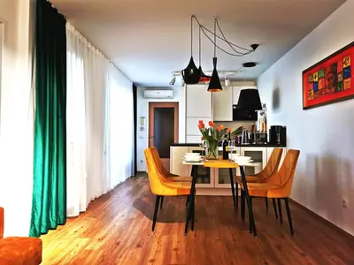 a dining room and kitchen with a table and chairs at Apartman PIKY No.10 in Moravske Toplice