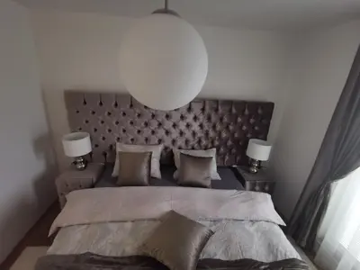 a bedroom with a large bed with two lamps at Apartman PIKY No.10 in Moravske Toplice