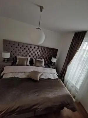 a bedroom with a large bed and a large window at Apartman PIKY No.10 in Moravske Toplice