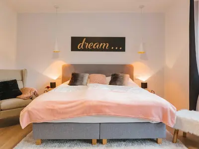 a bedroom with a bed with a dream sign above it at Villa M&J Bled in Zgornje Gorje