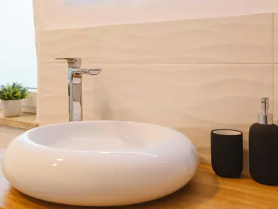 a white sink sitting on a counter in a bathroom at Villa M&J Bled in Zgornje Gorje