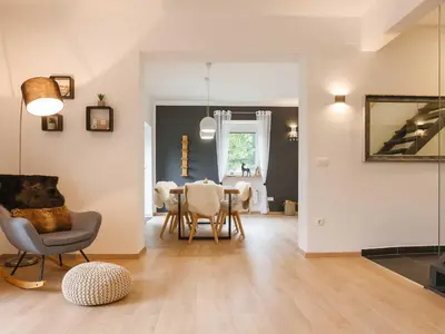 a living room with a dining room table and chairs at Villa M&J Bled in Zgornje Gorje
