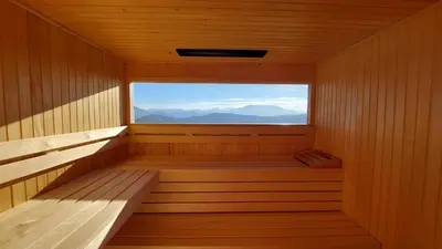 a sauna with a large window in the middle at Studio 1111 with Sauna & Hot Tub in Dravograd