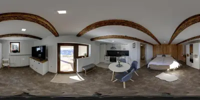 a bedroom with a bed and a table and chairs at Studio 1111 with Sauna & Hot Tub in Dravograd