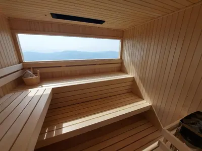 a sauna with a large window in it at Studio 1111 with Sauna & Hot Tub in Dravograd