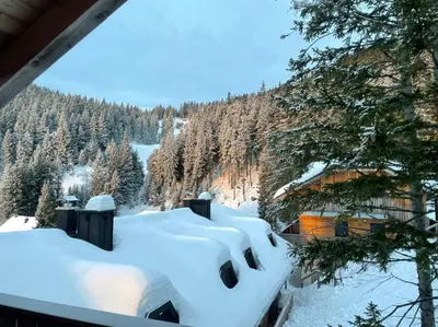 a room with snow on the roof of a house at OTTA Apartments Golte C2 in Mozirska Koča