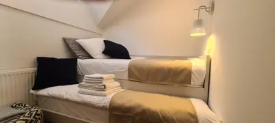 a small room with two beds with towels on them at OTTA Apartments Golte C2 in Mozirska Koča