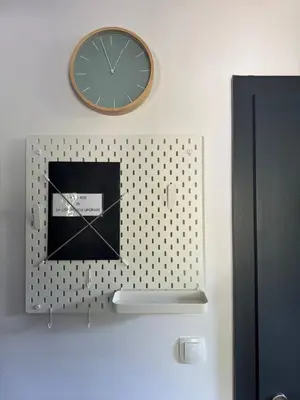 a clock is hanging on a wall at OTTA Apartments Golte C2 in Mozirska Koča