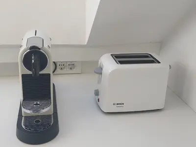 a toaster next to a toaster oven on a counter at Gloria Holiday - Apartment Bohinj in Bohinj
