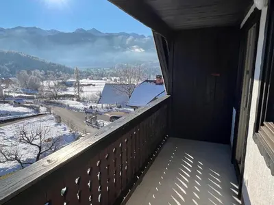 a balcony with a view of the snow covered mountains at Gloria Holiday - Apartment Bohinj in Bohinj