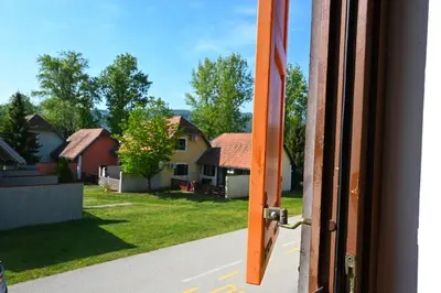 an open door with a view of houses at See You House, Terme Čatež 153 in Čatež ob Savi