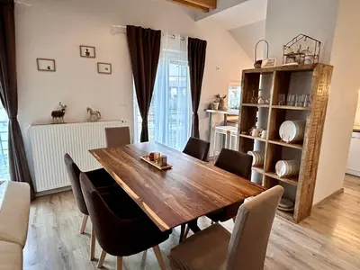 a dining room with a wooden table and chairs at Garden House in Kranj