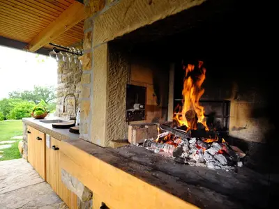 a large brick oven with a fire in it at Tomažev SVET in Zgornje Škofije
